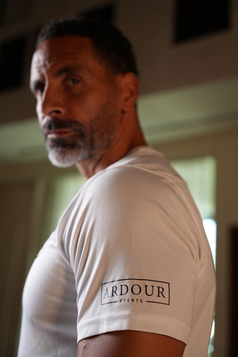 Rio Ferdinand wearing an Ardour Events shirt at a Football Escape camp