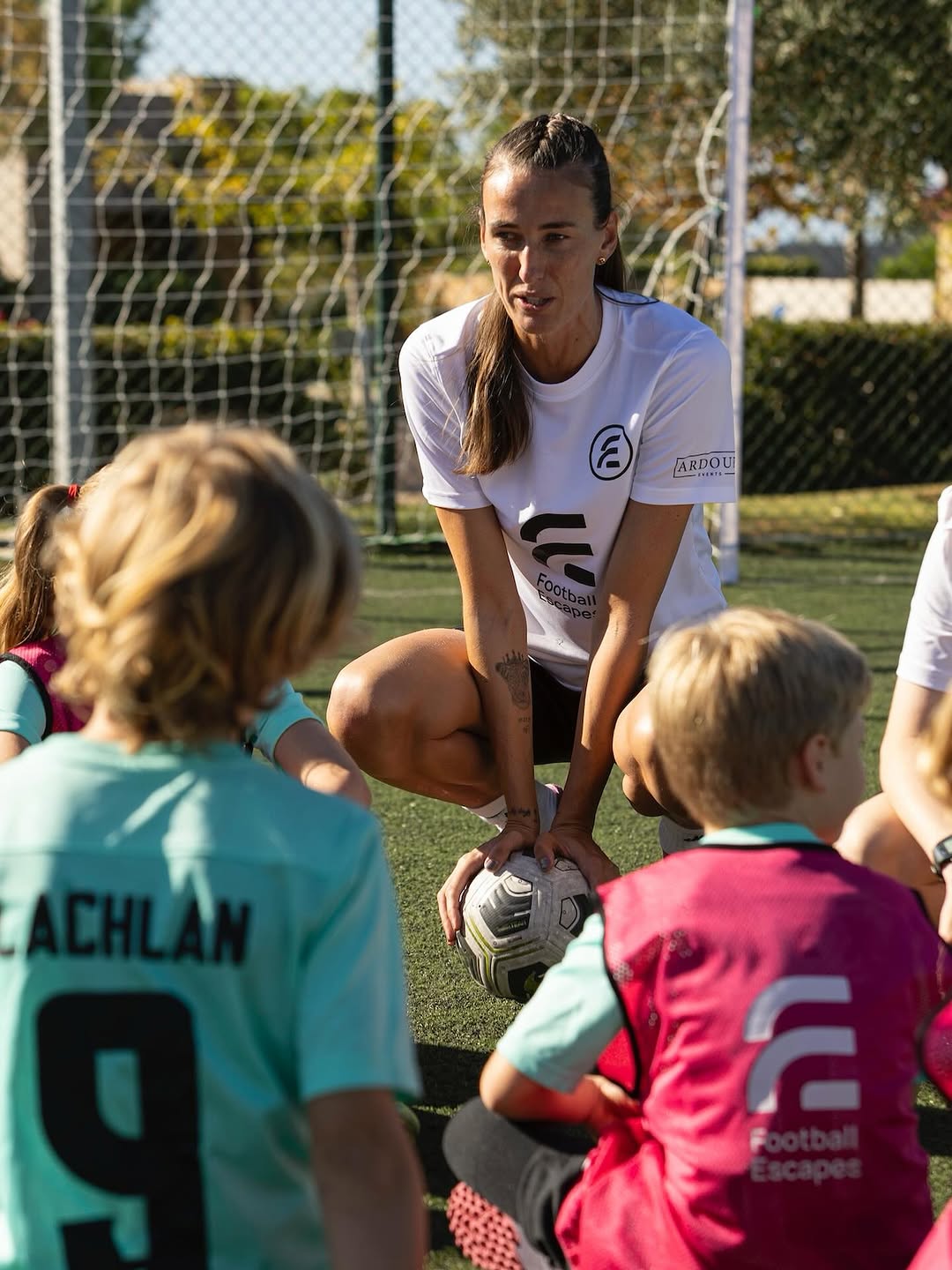 Football Escape coach talking to young players before a drill