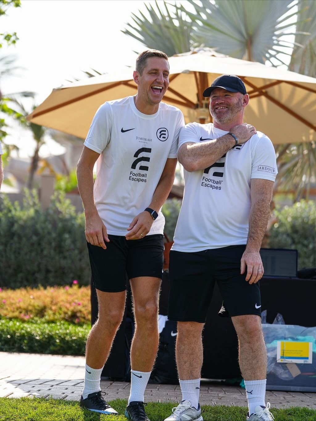 Wayne Rooney coaching young players at a Football Escape training camp in an Ardour Events shirt